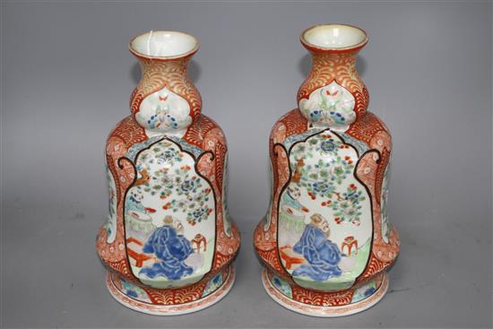 A pair of Japanese enamelled porcelain huqqa base vases, decorated with figures, height 25cm